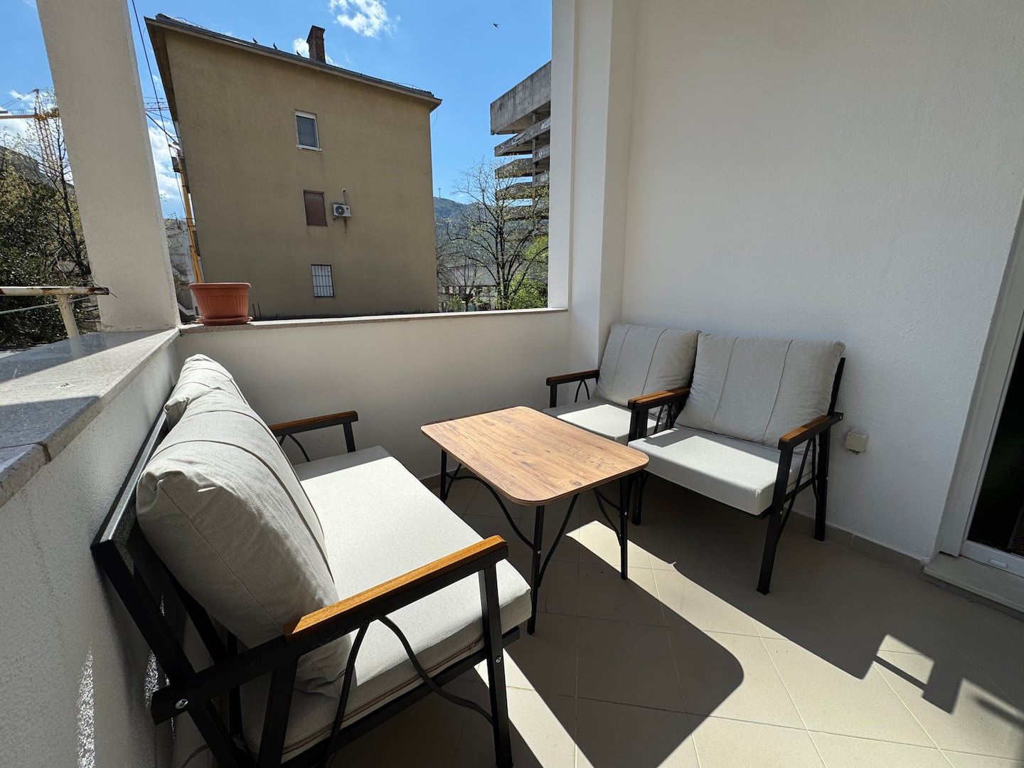 Terrace from another angle with outdoor sofas and a mountain view