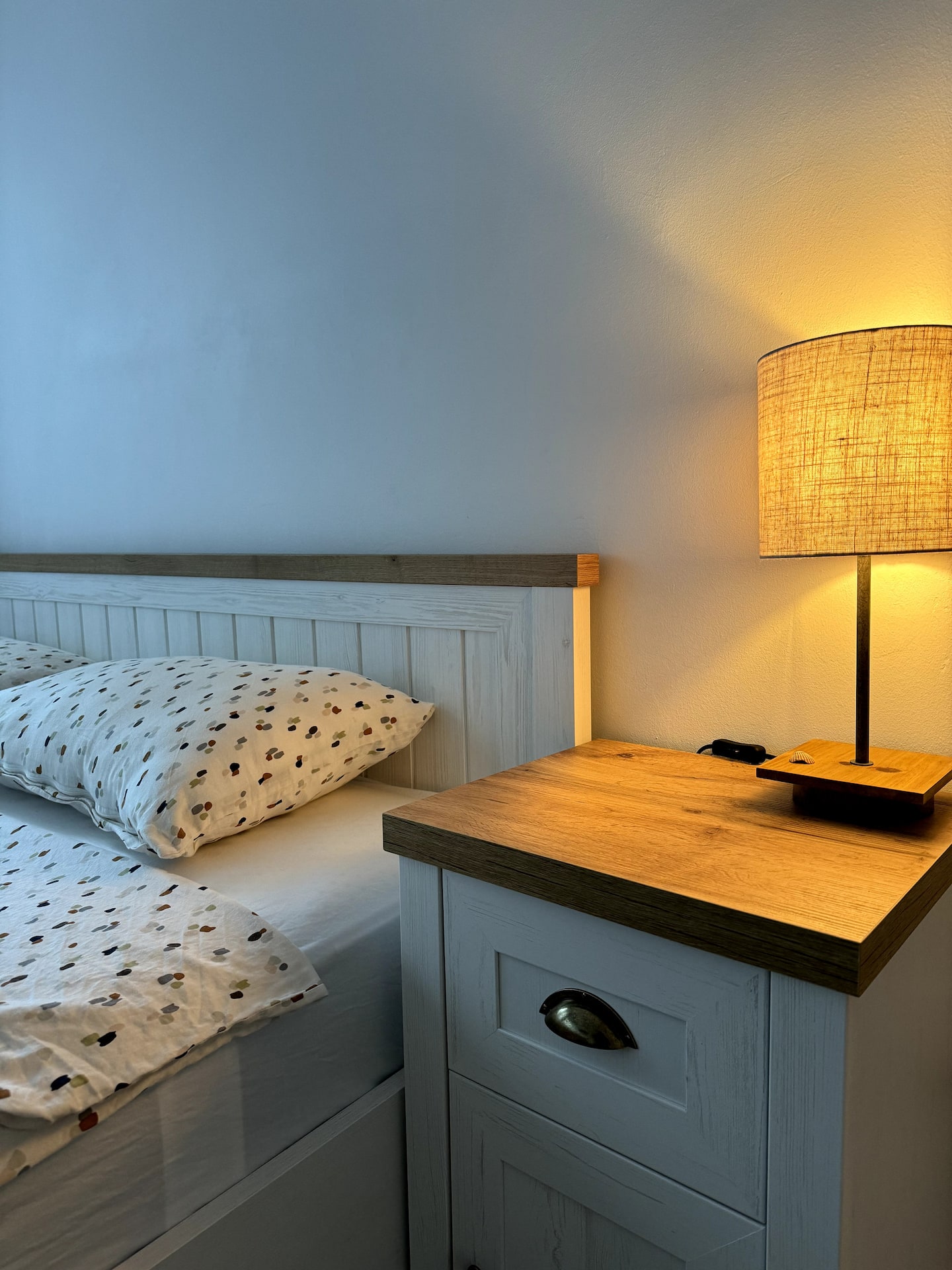 Bedroom detail with the king bed, nightstand and warm lamp