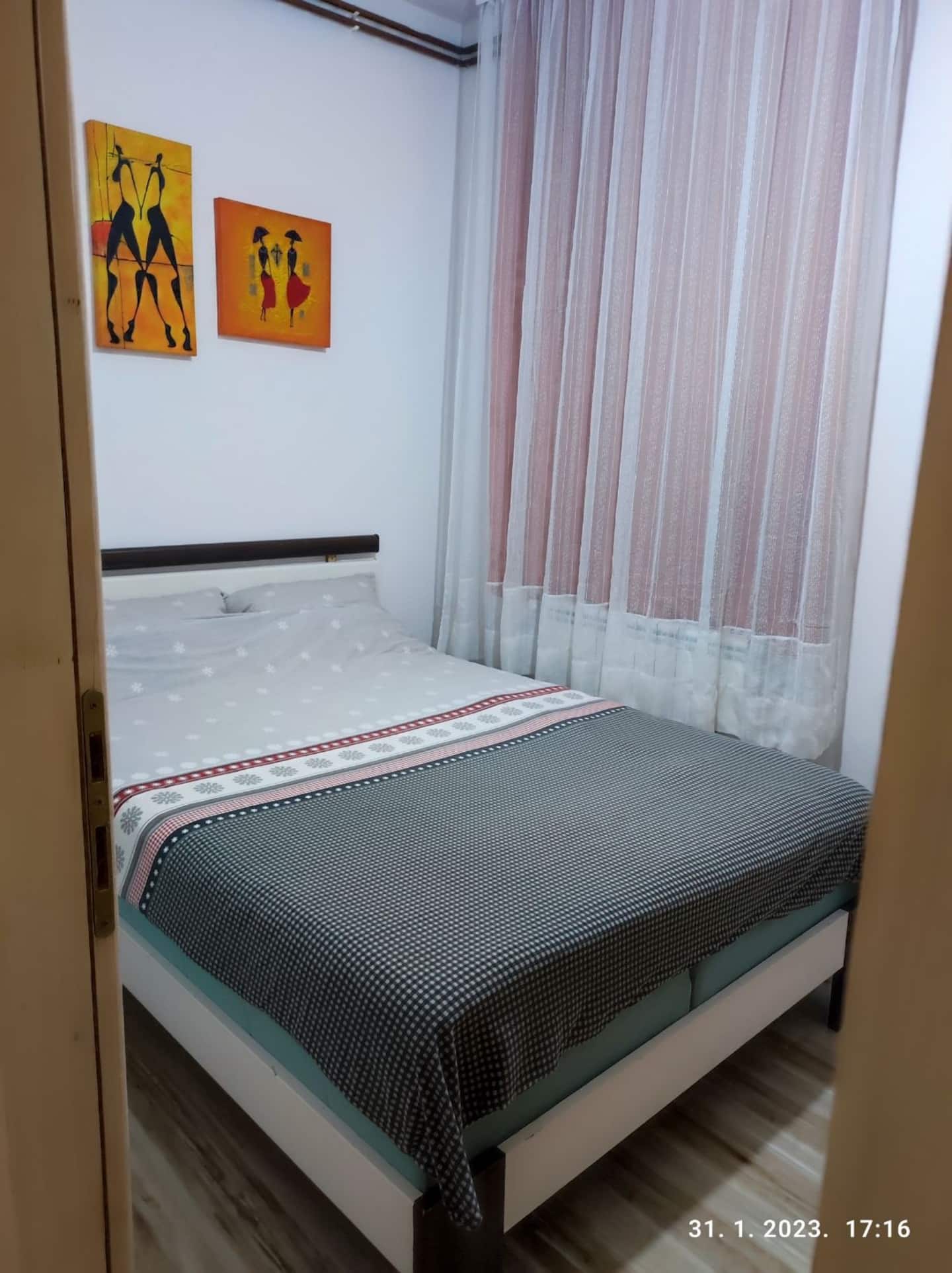 Bedroom with a double bed and framed artwork